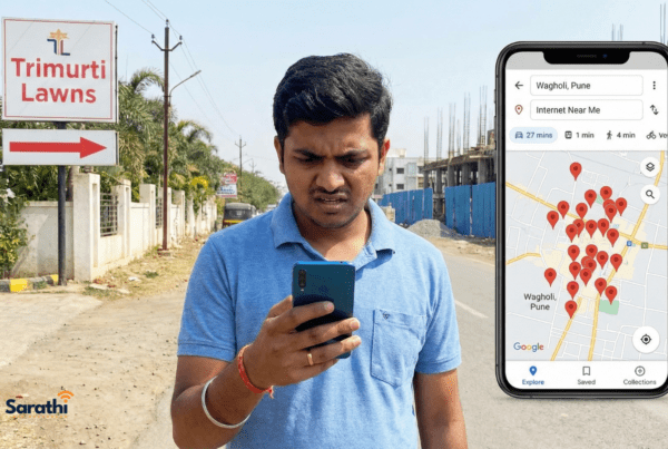 A confused man in Wagholi near Trimurti Lawns looking at a smartphone screen showing a cluttered map search for "Internet Near Me".
