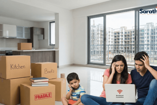 A stressed family moving into a new flat in Wagholi, surrounded by boxes, looking at a laptop with a "No Internet Connection" error.